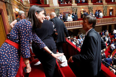 Nicolas Hulot (R), French Minister for the Ecological and Inclusive Transition, talks with French Junior Ecology Minister Brune Poirson after the speech of French President Emmanuel Macron during a special congress gathering both the upper and lower houses of the French parliament (National Assembly and Senate) in Versailles near Paris, France, July 9, 2018. REUTERS/Charles Platiau