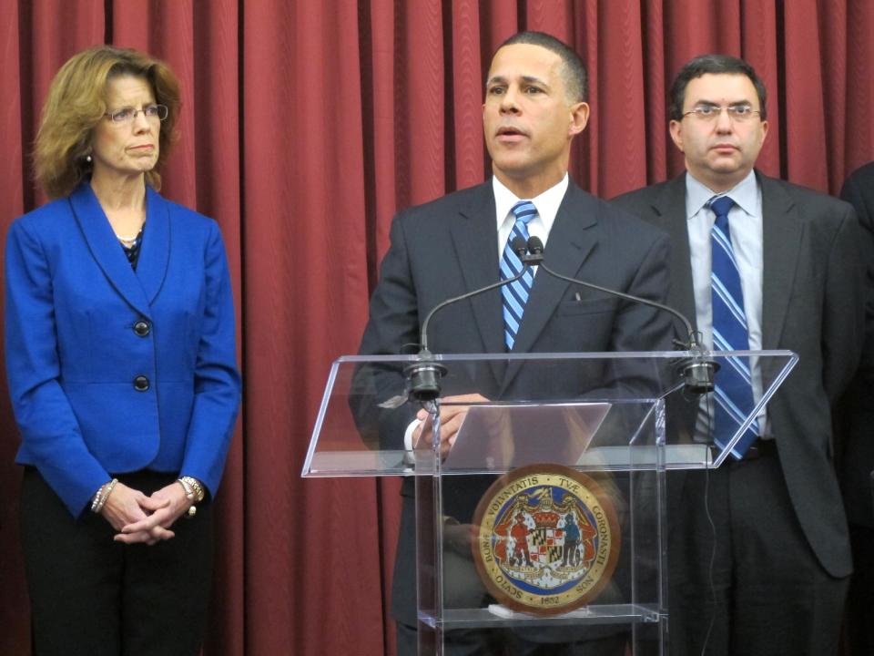 FILE - In this Dec 10, 2013 file photo, Lt. Gov. Anthony Brown, center, talks about problems with Maryland’s health care exchange in Baltimore. Joshua Sharfstein, Maryland’s health secretary, is standing to the right, and Carolyn Quattrocki, the interim director of the exchange, is standing to the left. With the open enrollment deadline approaching, some states running their own health insurance exchanges are focused less on getting robust sign-ups than on avoiding total disaster. Nevada, Massachusetts, Vermont, Maryland and Oregon are among the states facing severe technical and administrative problems, which have led to firings of top officials and contract cancellations for key software companies. (AP Photo/Brian Witte)