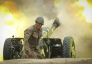 An Armenian serviceman fires a cannon towards Azerbaijan positions in the self-proclaimed Republic of Nagorno-Karabakh, Azerbaijan, Tuesday, Sept. 29, 2020. Armenian and Azerbaijani forces accused each other of attacks on their territory Tuesday, as fighting over the separatist region of Nagorno-Karabakh continued for a third straight day following the reigniting of a decades-old conflict. (Sipan Gyulumyan/Armenian Defense Ministry Press Service/PAN Photo via AP)