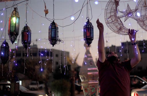 A street vendor plugs in decorations for Ramadan in Amman, Jordan, Thursday, July 19, 2012. Religious authorities in Jordan declared that Friday will be the start of the holy month of Ramadan, a period devoted to dawn-to-dusk fasting, prayers and spiritual introspection. Ramadan begins around 11 days earlier each year. Its start is calculated based on the sighting of the new moon, which marks the beginning of the Muslim lunar month that varies between 29 or 30 days. (AP photo/Mohammad Hannon)