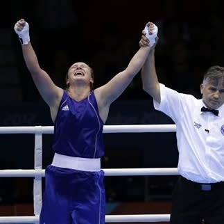 Kazakhstan's Marina Volnova celebrates, left, after defeating Britain's Savannah Marshall, right, in a women's middleweight 75-kg quarterfinal boxing match at the 2012 Summer Olympics, Monday, Aug. 6, 2012, in London. (AP Photo/Mike Groll)