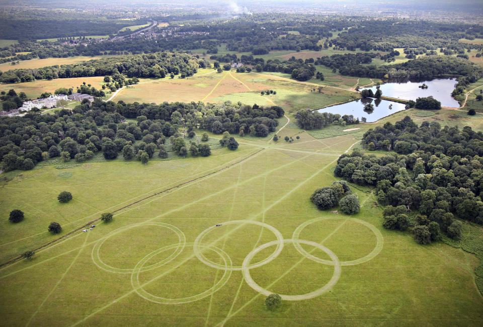 In this handout image released by LOCOG on July 9, 2012, an aerial view of Olympic Rings cut into the grass of Richmond Park, London, England. The rings, which are approximately 300 metres wide and over 135 metres tall, are visible on the Heathrow flight path, ready to welcome athletes and visitors to the London 2012 Olympic Games. The five rings represent the five continents and the meeting of athletes from throughout the world at the Olympic Games. (Photo by David Poultney for LOCOG via Getty Images)