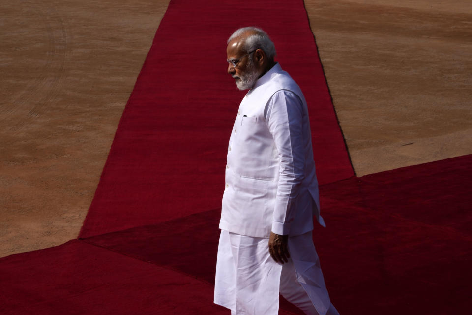 Indian Prime Minister Narendra Modi walks to receive German Chancellor Olaf Scholz, for latter's ceremonial reception at the Indian presidential palace, in New Delhi, India, Saturday, Feb. 25, 2023. (AP Photo/Manish Swarup)