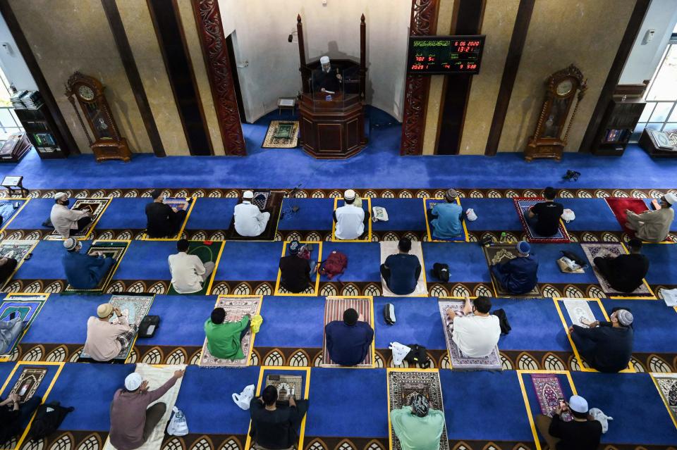 Muslim devotees observe social distancing while attending the Friday prayers at Al-Istighfar Mosque after the government lifted restrictions due to the COVID-19 coronavirus pandemic in Singapore on June 26, 2020. - Singapore in early June significantly eased a partial lockdown imposed since April to contain the coronavirus, including allowing mosques to reopen for congregational Friday prayers but with each session limited to only 50 congregants, who must booked online in advance. (Photo by Roslan RAHMAN / AFP) (Photo by ROSLAN RAHMAN/AFP via Getty Images)