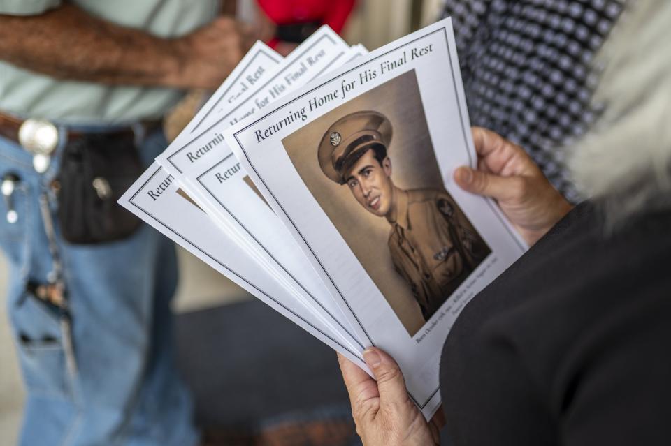 Programs for the funeral of Sgt. Turner Yearwood Johnston are handed out at Belton's Dossman Funeral Home on Oct. 21