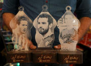 Mohamed Gamal shows lanterns with a portraits of Egyptian professional football players; Stoke City's Ramadan Sobhi (L), AC Roma's Mohamed Salah (C), and FC Basel's Omar Gaber, in Cairo, Egypt May 16, 2017. Picture taken May 16, 2017. REUTERS/Mohamed Abd El Ghany