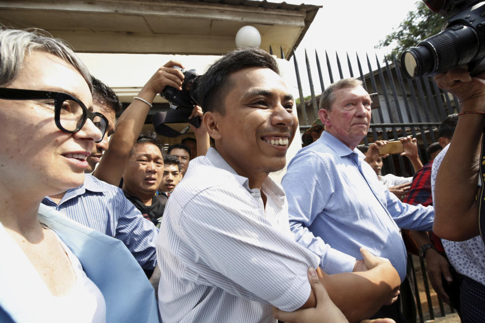 Reuters reporter Kyaw Soe Oo, center, reacts after being freed from Insein Prison in Yangon, Myanmar, Tuesday, May 7, 2019. Two Reuters journalists who were imprisoned for breaking Myanmar's Official Secrets Act over reporting on security forces' abuses of Rohingya Muslims were pardoned and released Tuesday, the prison chief and witnesses said. (Ann Wang/Pool Photo via AP)