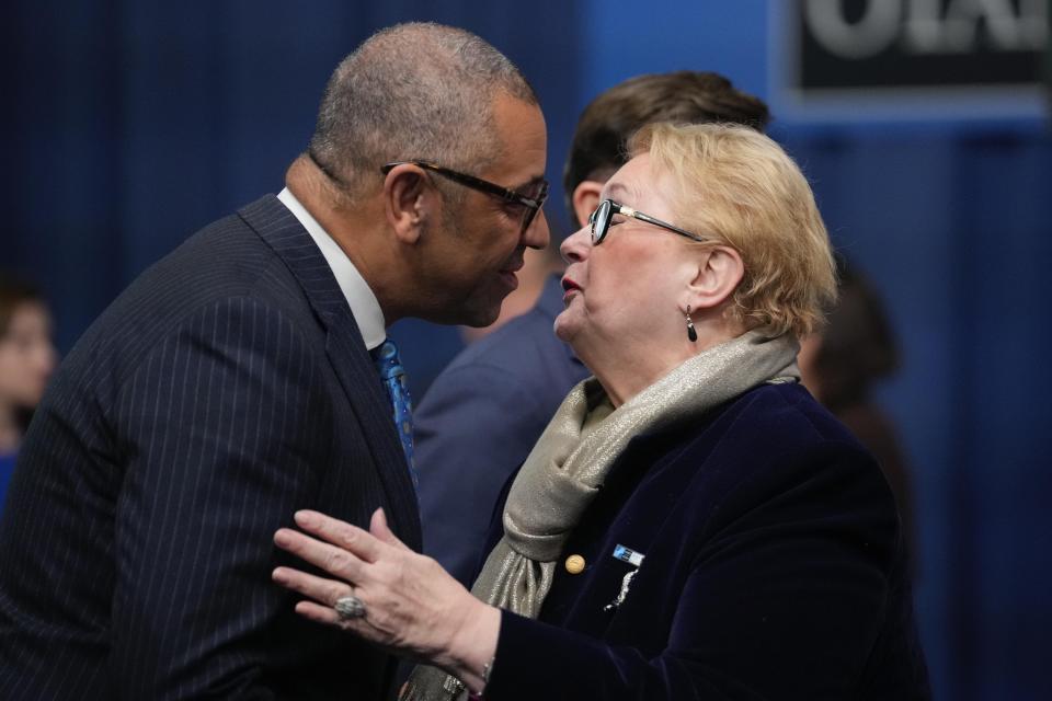 Britain's Foreign Secretary James Cleverly, left, greets Bosnia Herzegovina Foreign Minister Bisera Turkovic during the second day of the meeting of NATO Ministers of Foreign Affairs in Bucharest, Romania, Wednesday, Nov. 30, 2022. (AP Photo/Andreea Alexandru)