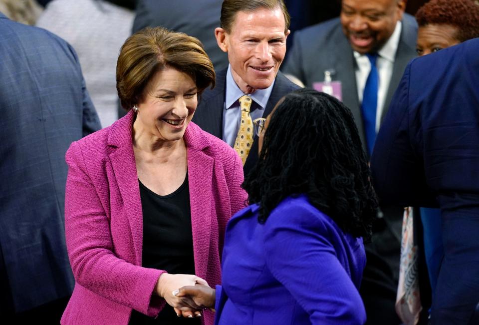 Supreme Court nominee Judge Ketanji Brown Jackson is greeted by Sen. Amy Klobuchar, D-Minn., and Sen. Richard Blumenthal, D-Conn., as she arrives for her confirmation hearing before the Senate Judiciary Committee on March 21, 2022, on Capitol Hill in Washington.