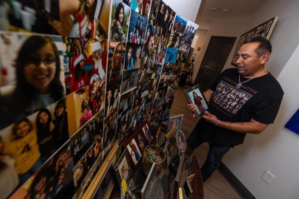 Adolph Alvarez looks at photos at an altar for his daughter Abigil, who died from fentanyl poisoning on May 14, 2022, at 18 years of age.