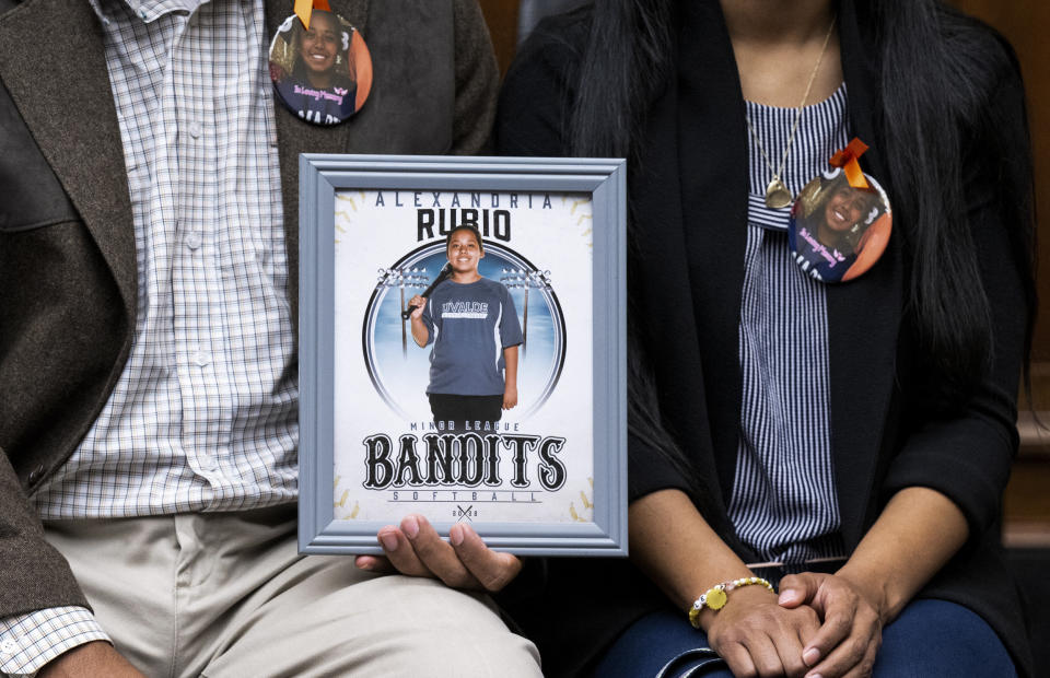 Image: Parents of 10 year old Alexandria Rubio, who was killed during the shooting at Robb Elementary School in Uvalde, Texas, in May 2022, hold a photo of their daughter during a House Committee on Oversight and Reform hearing on Examining the Practices and Profits of Gun Manufacturers in Washington, D.C., on July 27, 2022. (Saul Loeb / AFP via Getty Images)
