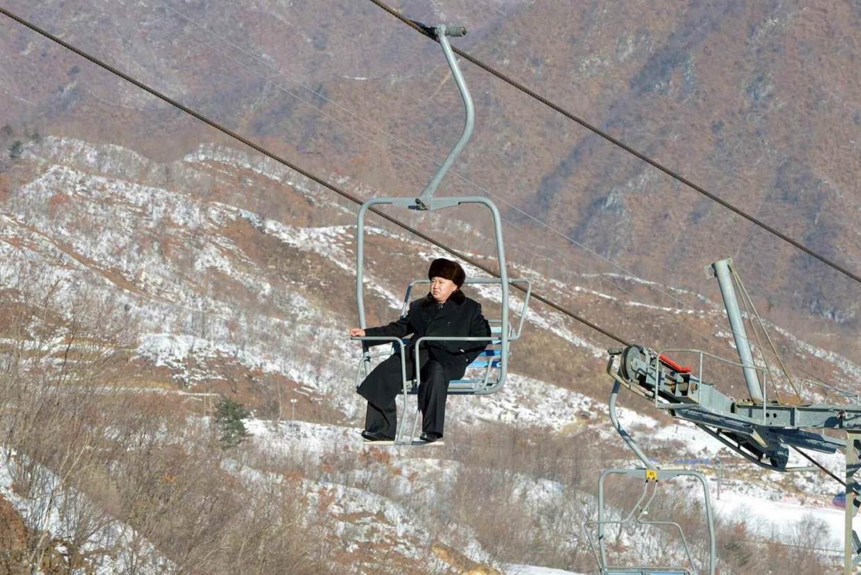 <p>Kim Jong Un riding a ski lift </p> (RODONG SINMUN / EPA)