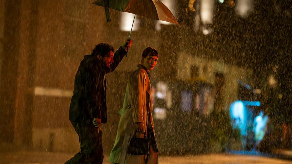 John Magaro and Britt Lower hold hands in the rain in 'The Shallow Tale of a Writer Who Decided to Write About a Serial Killer’