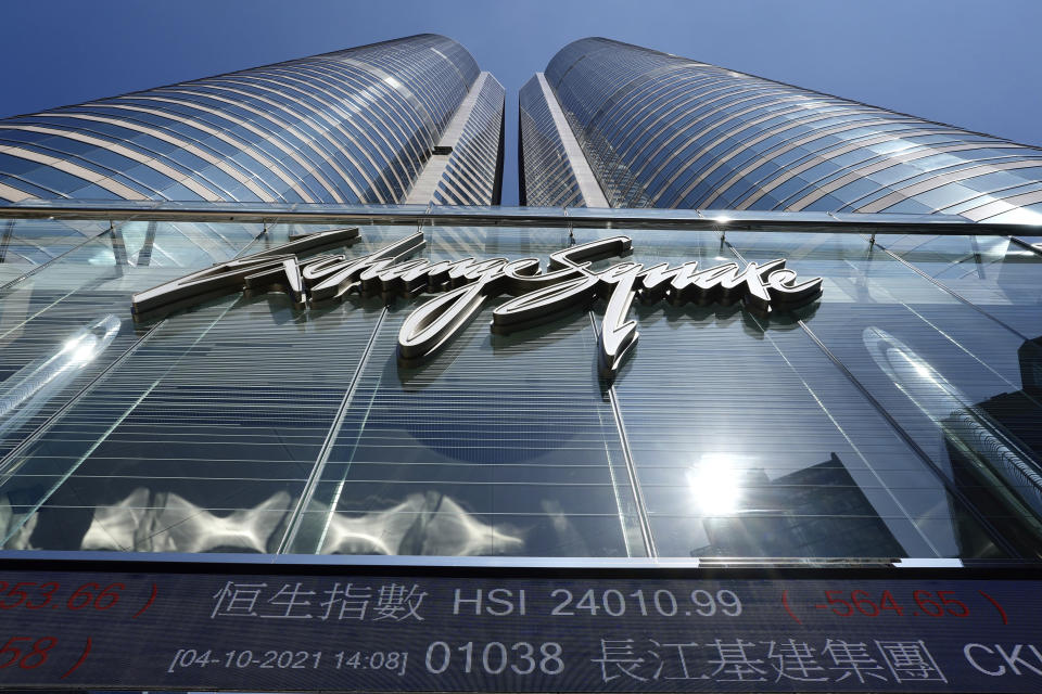 A bank's electronic board displays the Hong Kong share index at Hong Kong Stock Exchange Monday, Oct. 4, 2021. Shares in troubled real estate developer China Evergrande Group and its property management unit Evergrande Property Services were suspended from trading Monday in Hong Kong. (AP Photo/Vincent Yu)