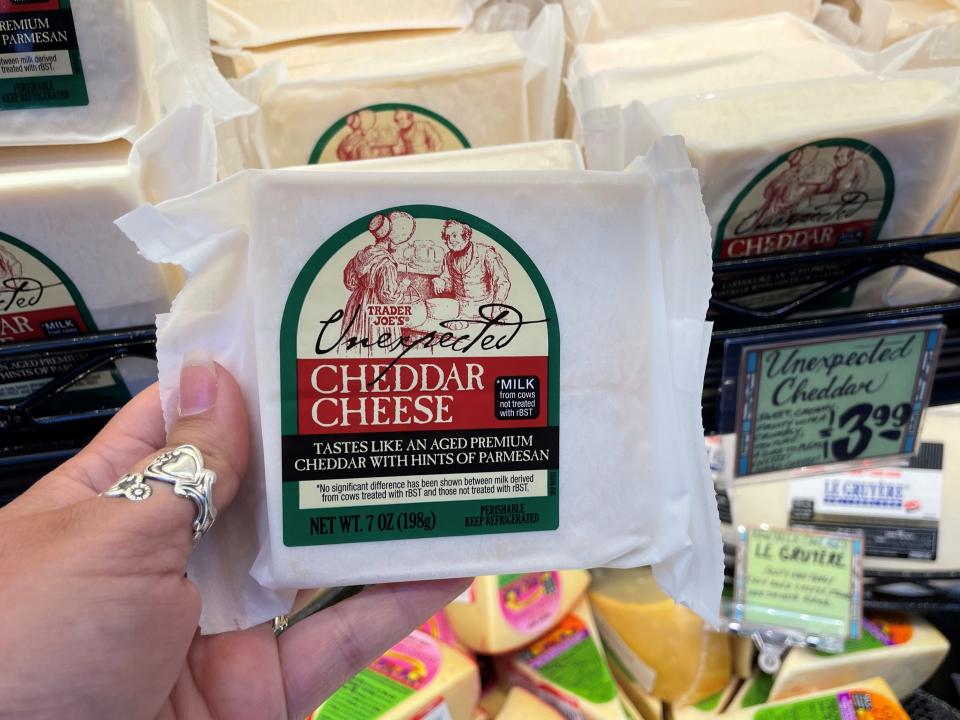 trader joe's unexpected cheddar in writer's hand