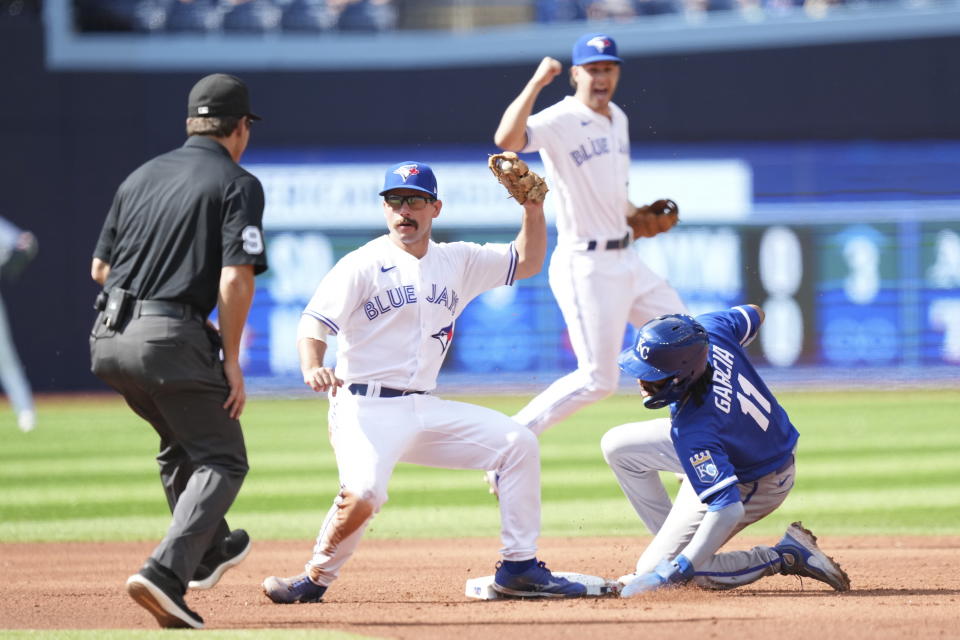 Toronto Blue Jays second baseman Davis Schneider tags out Kansas City Royals third baseman Maikel Garcia on a steal attempt during the sixth inning of a baseball game in Toronto on Sunday, Sept. 10, 2023. (Nathan Denette/The Canadian Press via AP)