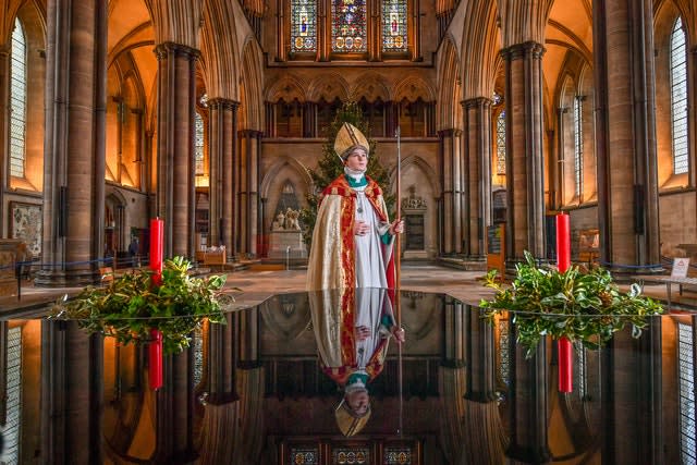 Chorister Bishop Sebastian Kunzer stands beside the baptismal font as he prepares for the Feast of St Nicholas at Salisbury Cathedral (Ben Birchall/PA)
