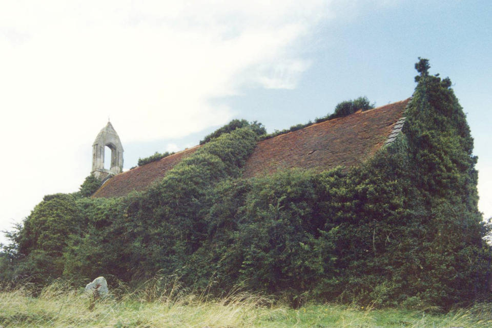 St Denis Church East Hatley hidden in ivy. (SWNS)