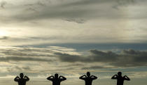 A group of men perform physical exercise training as sun set at Galle Face green in Colombo January 9, 2013. REUTERS/Dinuka Liyanawatte (SRI LANKA - Tags: SOCIETY TPX IMAGES OF THE DAY)