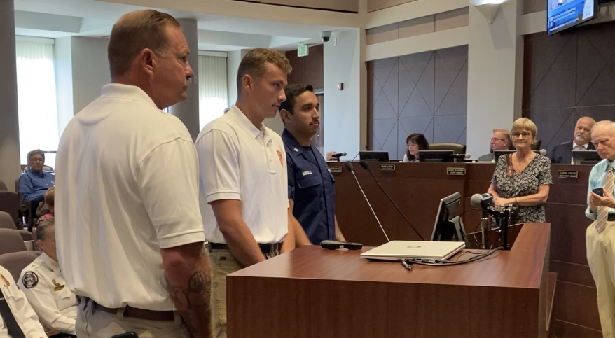 Thomas McGibeny, Declan Outlaw and Antonio Gonzalez stand before the Volusia County Council as they are recognized for their bravery in rescuing people from the Ponce Inlet Jetty in June.