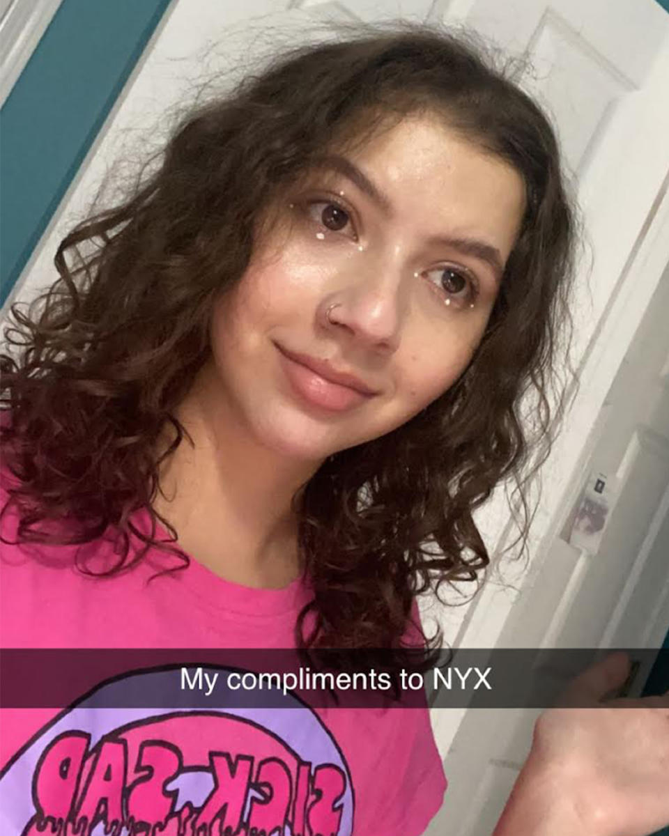 BuzzFeed Staffer Maya Ogolini smiles in a Snapchat selfie with a caption that reads "My compliments to NYX"