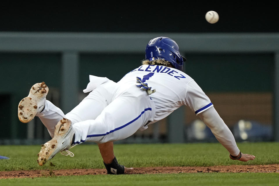 Kansas City Royals' MJ Melendez dives back to third to be tagged out after being caught during off base by during the fourth inning of a baseball game against the Detroit Tigers Tuesday, July 18, 2023, in Kansas City, Mo. (AP Photo/Charlie Riedel)