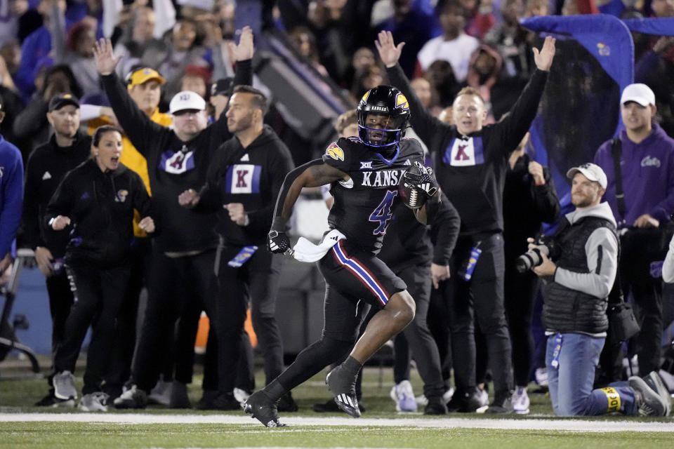 Kansas running back Devin Neal runs for a touchdown during the first half of an NCAA college football game against Kansas State Saturday, Nov. 18, 2023, in Lawrence, Kan. (AP Photo/Charlie Riedel)