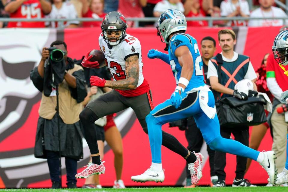 Dec 3, 2023; Tampa, Florida, USA; Tampa Bay Buccaneers wide receiver Mike Evans (13) runs with the ball against the Carolina Panthers in the fourth quarter at Raymond James Stadium. Mandatory Credit: Nathan Ray Seebeck-USA TODAY Sports