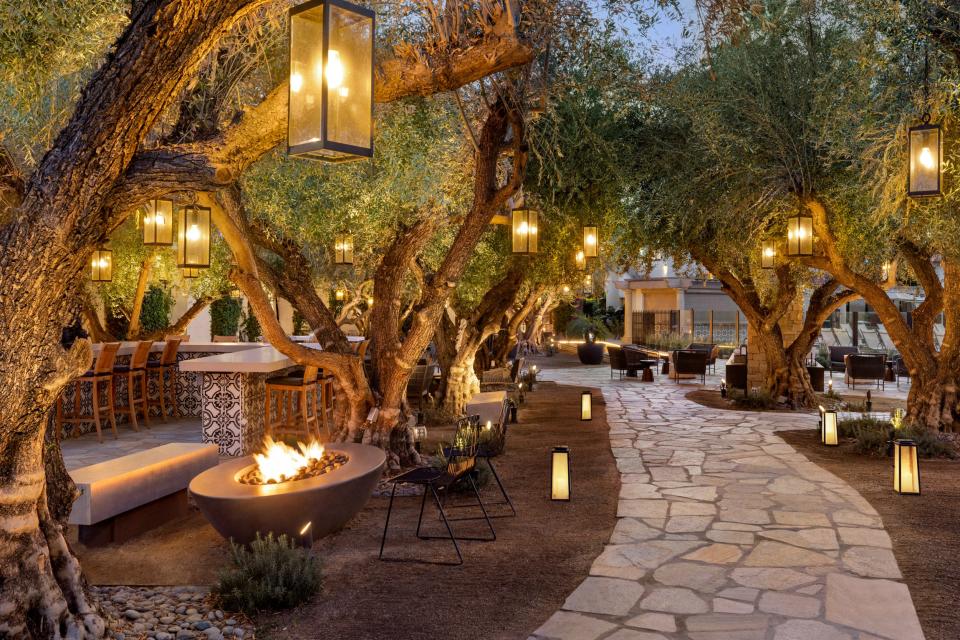 walkway with fire pits and trees