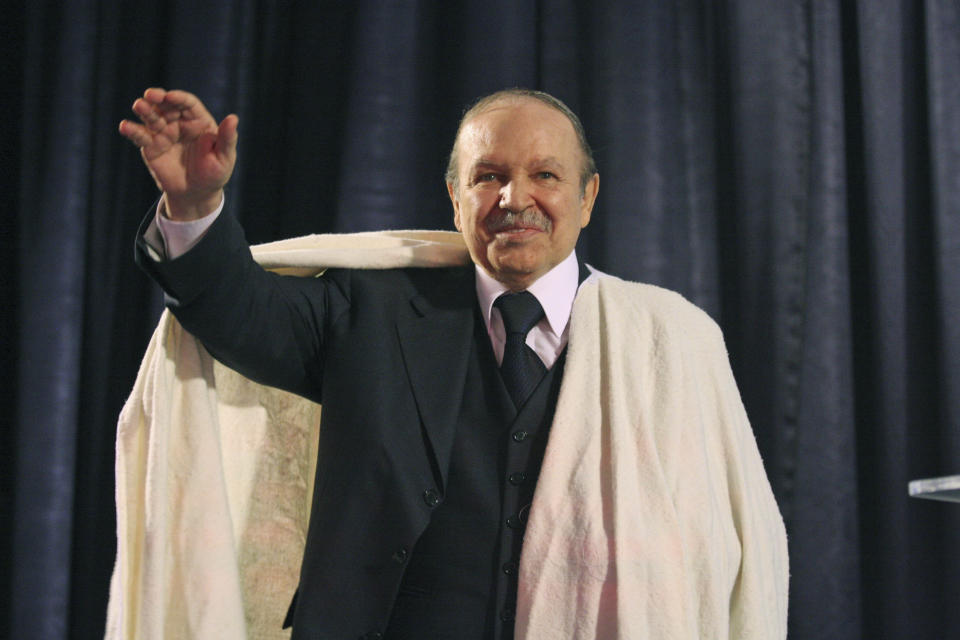 FILE - In this March 27, 2009 file photo Algerian President Abdelaziz Bouteflika salutes the crowd while dressed in a traditional "Burnous" robe from the Kabyle ethnic minority in Tizi Ouzou, Algeria. Embattled Algerian President Abdelaziz Bouteflika says he will step down before his fourth term ends on April 28. In a short statement issued on Monday April 1, 2019, the president's office said Bouteflika would take "important steps to ensure the continuity of the functioning of state institutions" during a transition period following his departure from the post he's held since 1999. ( AP Photo/Alfred de Montesquieu, file)