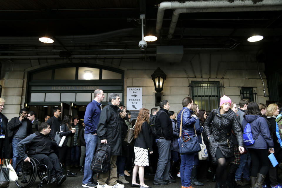 Commuters wait to enter the PATH station in Hoboken, N.J., Tuesday, April 4, 2017. A minor derailment on Monday at Penn Station involving a New Jersey Transit train and other rail issues are causing major problems for New York City metro area commuters. (AP Photo/Seth Wenig)