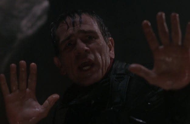 Tommy Lee Jones as Samuel Gerard puts his hands up when he encounters Richard Kimble in a tunnel