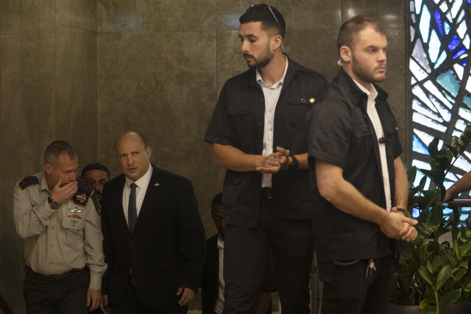 Israeli Prime Minister Naftali Bennett, center, arrives for the weekly cabinet meeting in Jerusalem, Sunday, May 8, 2022. (AP Photo/Maya Alleruzzo, Pool)