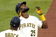 Pittsburgh Pirates' Gregory Polanco (25) celebrates as he stands on first base after driving in a run with a single off Philadelphia Phillies starting pitcher Vince Velasquez during the second inning of a baseball game in Pittsburgh, Friday, July 30, 2021. (AP Photo/Gene J. Puskar)