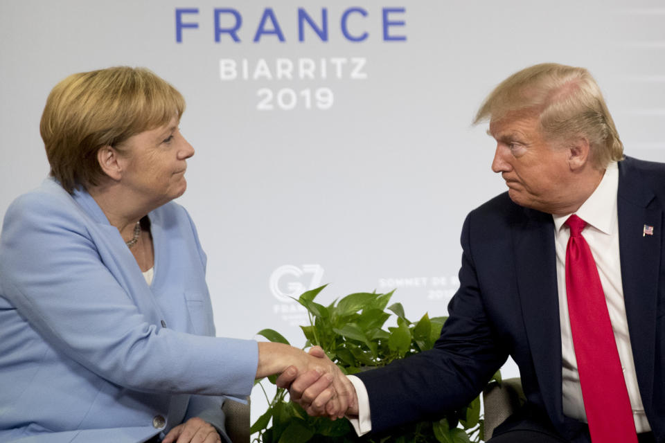 FILE - In this Aug. 26, 2019 file photo, U.S. President Donald Trump and German Chancellor Angela Merkel, left, shake hands during a bilateral meeting at the G-7 summit in Biarritz, France. Angela Merkel has just about seen it all when it comes to U.S. presidents. Merkel on Thursday makes her first visit to the White House since Joe Biden took office. He is the fourth American president of her nearly 16-year tenure as German chancellor. (AP Photo/Andrew Harnik, File)