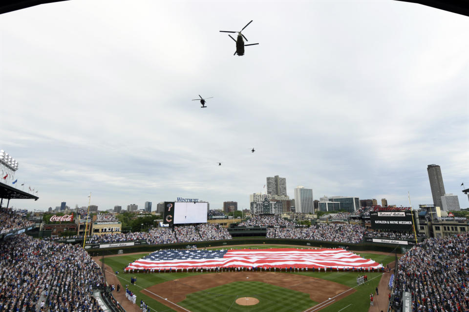 Helicopters fly over Wrigley Field during a Fourth of July tribute before a baseball game between the Chicago Cubs and Philadelphia Phillies Thursday, July 4, 2024, in Chicago. (AP Photo/Paul Beaty)