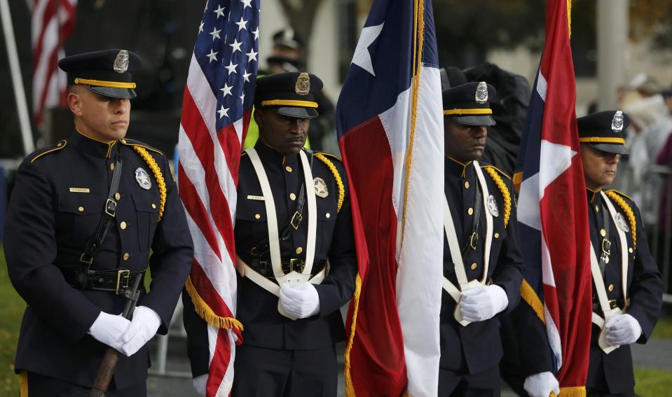 Members of a Dallas Police Department honor guard stand in Dealey Plaza during ceremonies marking the 50th anniversary of JFK's assassination in Dallas