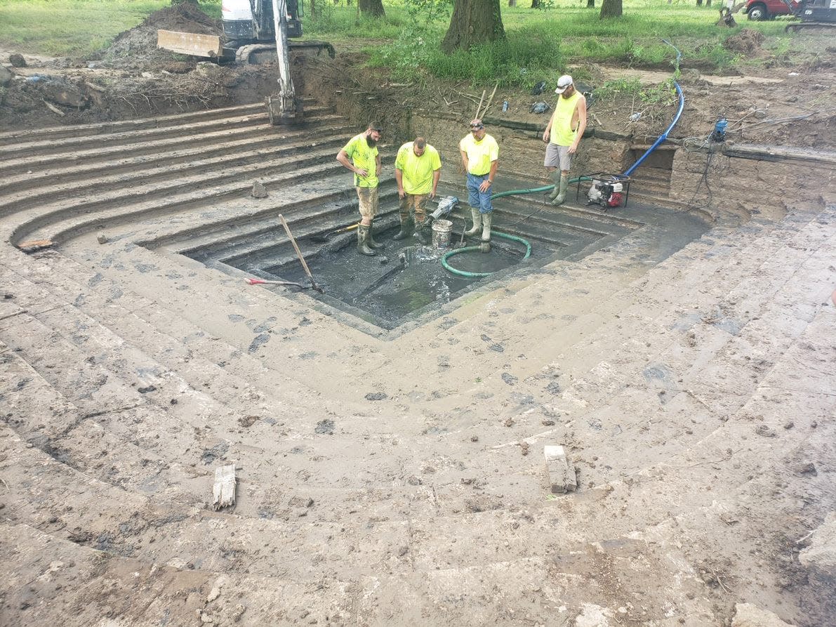 A crew works at the bottom of the Neptune Spring in French Lick.