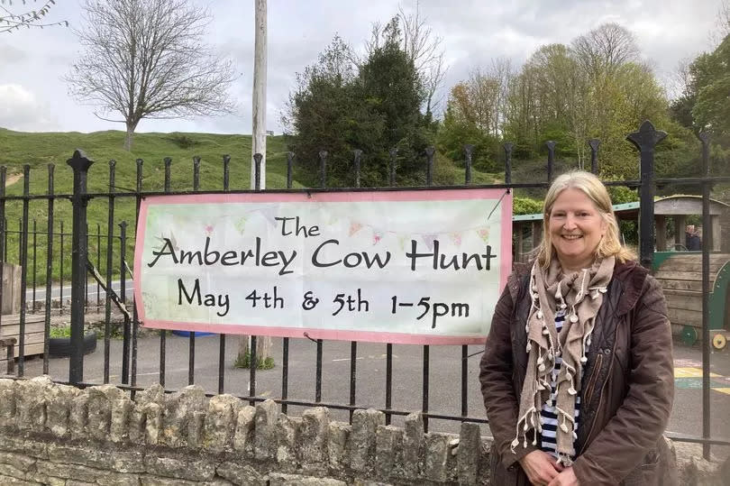 Bronwen Edwards with the Amberley Cow Hunt banner in the village