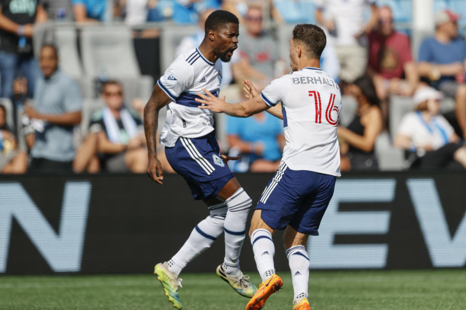 Vancouver Whitecaps striker Tosaint Ricketts, left, celebrates with teammate Sebastian Berhalter after scoring against Charlotte FC in the second minute of the first half of an MLS soccer match in Charlotte, N.C., Sunday, May 22, 2022. (AP Photo/Nell Redmond)