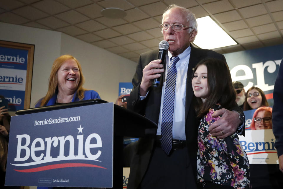 Democratic presidential candidate Sen. Bernie Sanders, I-Vt., introduces his granddaughter Tess, right, as his wife Jane Sanders watches at left, during a campaign event at the SEA/ SEIU Union Hall, Saturday, Feb. 8, 2020, in Concord, N.H. (AP Photo/Elise Amendola)