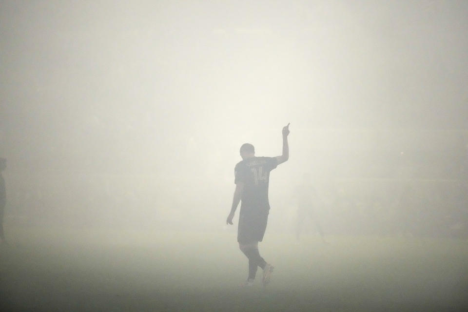 Los Angeles FC defender Giorgio Chiellini gestures amid smoke during the first half in the MLS playoff Western Conference final soccer match against Houston Dynamo, Saturday, Dec. 2, 2023, in Los Angeles. (AP Photo/Marcio Jose Sanchez)