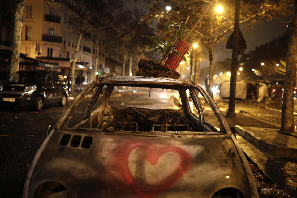 A charred car is pictured near the Arc de Triomphe after the demonstration, Dec.1, 2018, in Paris. (Photo: Kamil Zihnioglu/AP)