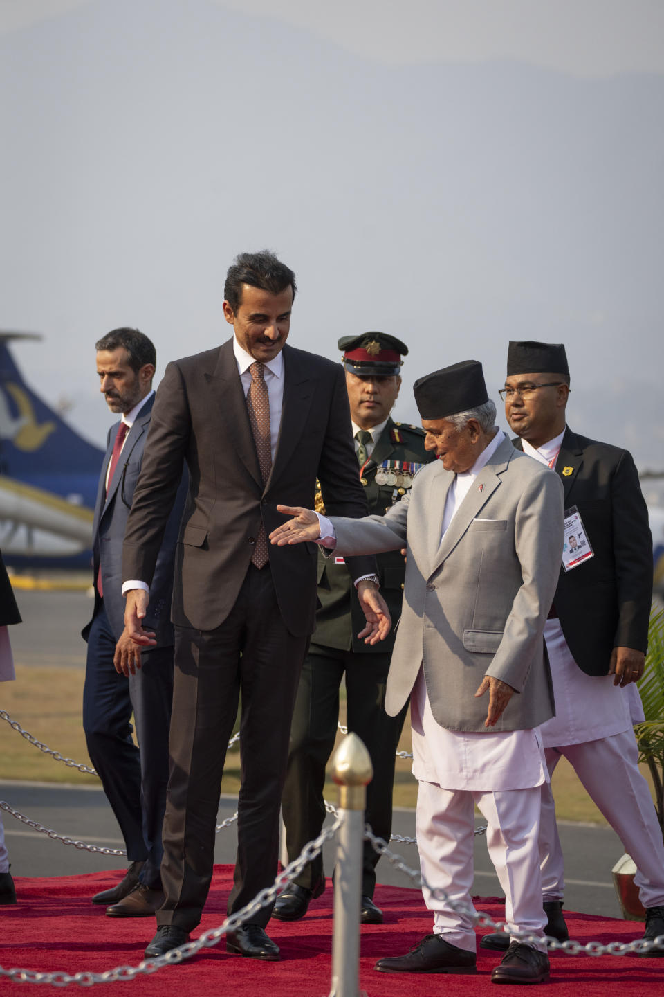 Qatar's Emir Sheikh Tamim bin Hamad Al Thani, is received by Nepal President Ram Chandra Poudel, right as he arrives at the airport in Kathmandu, Nepal, Tuesday, April 23, 2024. The emir is on a two-days visit to the Himalayan nation. (AP Photo/Niranjan Shreshta)