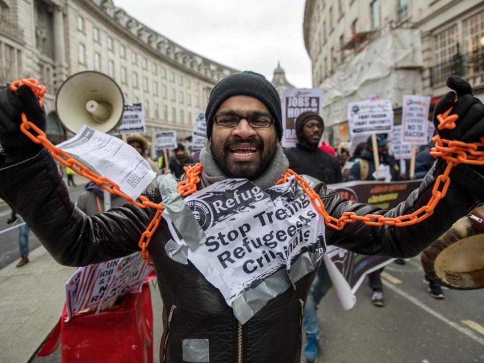 An anti-racism protester with chains around his neck (Getty)