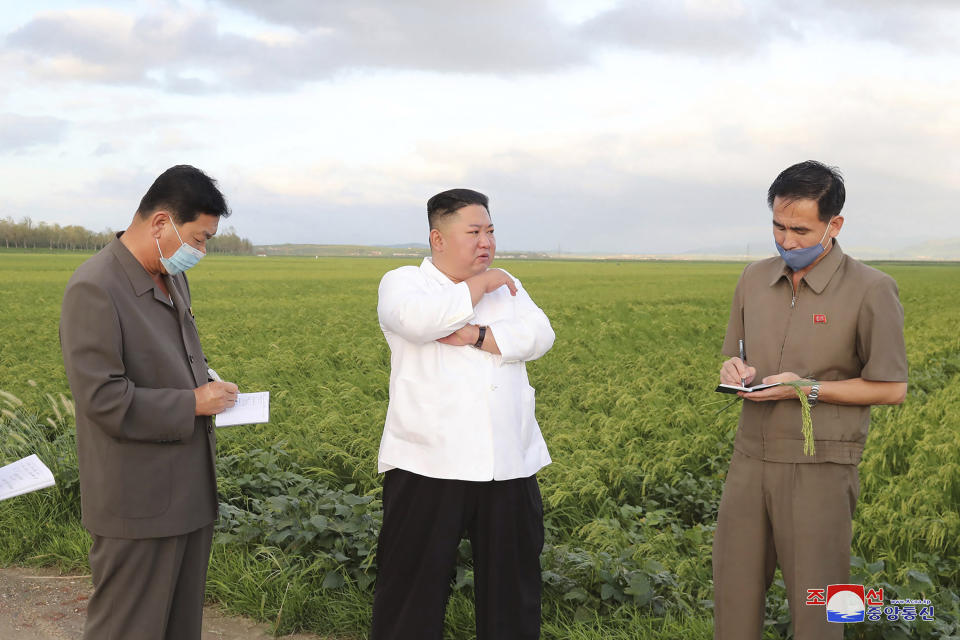 In this undated photo provided on Friday, Aug. 28, 2020, by the North Korean government, North Korean leader Kim Jong Un, center, speaks during his visit to a western coastal area in South Hwanghae province, North Korea, where Typhoon Bavi made landfall early Thursday, Aug. 27. Independent journalists were not given access to cover the event depicted in this image distributed by the North Korean government. The content of this image is as provided and cannot be independently verified. Korean language watermark on image as provided by source reads: "KCNA" which is the abbreviation for Korean Central News Agency. (Korean Central News Agency/Korea News Service via AP)