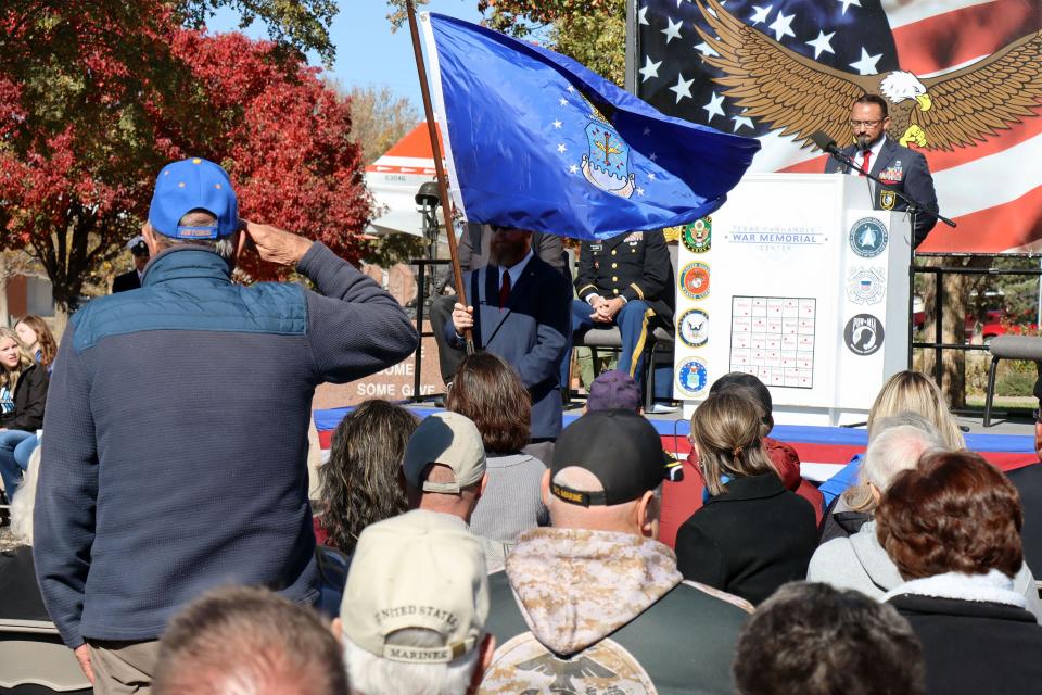 A U.S. Navy veteran stands to salute the U.S. Navy flag as the military branches are honored at the Texas Panhandle War Memorial Center in this November 2023 file photo.