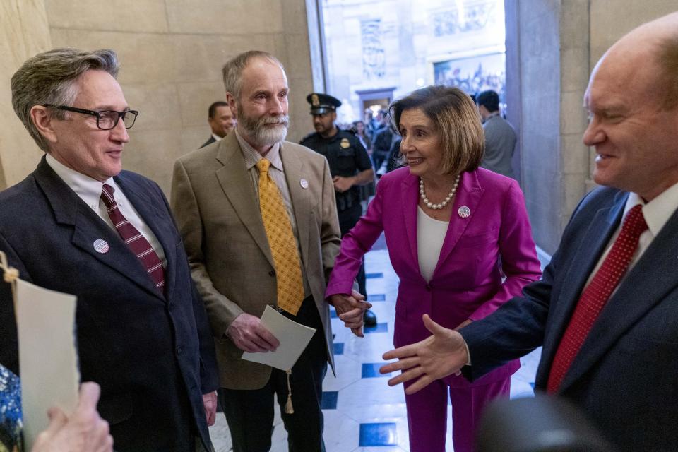 House Speaker Nancy Pelosi of Calif., second from right, introduces former President Harry S. Truman's eldest grandson Clifton Truman Daniel, left, to Sen. Chris Coons, D-Del., right, after a ceremony to unveil the Congressional statue of the former president in the Rotunda of the U.S. Capitol Building in Washington, Thursday, Sept. 29, 2022. (AP Photo/Andrew Harnik)