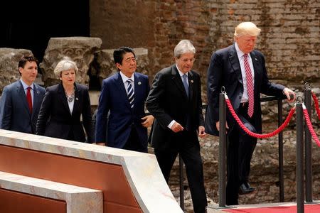 FILE PHOTO: From R-L, U.S. President Donald Trump, Italian Prime Minister Paolo Gentiloni, Japanese Prime Minister Shinzo Abe, Britain's Prime Minister Theresa May, Canadian Prime Minister Justin Trudeau arrive for a family photo at the G7 Summit in Taormina, Sicily, Italy, May 26, 2017. REUTERS/Jonathan Ernst/File Photo