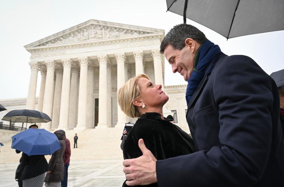 Bridget Kelly, former deputy chief of staff for then-New Jersey Gov. Chris Christie, and Bill Baroni, his top appointee at the Port Authority of New York and New Jersey, embrace outside the Supreme Court after oral argument Tuesday.